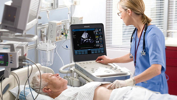 (opens in the same window) Echocardiologist treating cardiovascular disease patient